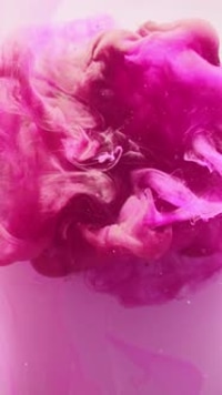 Pink and Maroon Ink Swirling in Water