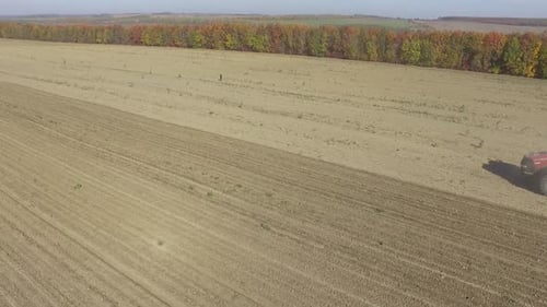 Big red combine working on the field cultivating and applying nitrogen ASP