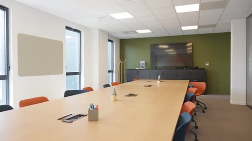 slow revealing shot of a large meeting room with a tv for presentations in an office