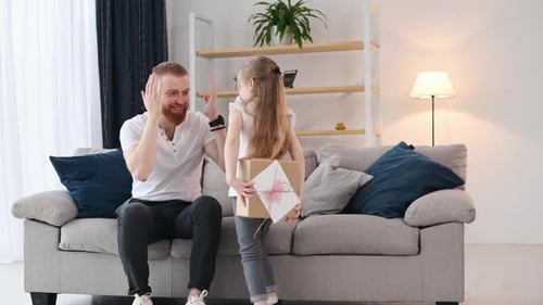 Loving Daughter Giving Gift to Dad on Birthday