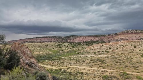 Flying backwards over rocky cliffs looking at storm clouds at Flaming Gorge