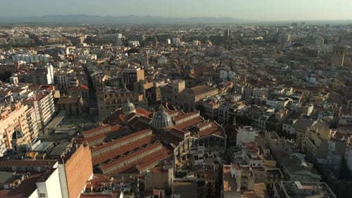 Orbiting Aerial shot of Valencia central market and old town, Spain