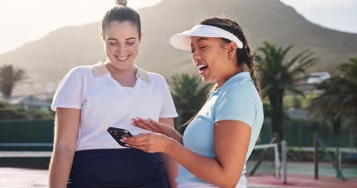Tennis Friends Laughing at Smartphone on Court