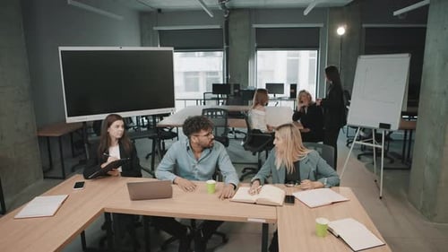 Meeting of business professionals discussing strategies in a modern office space during the day