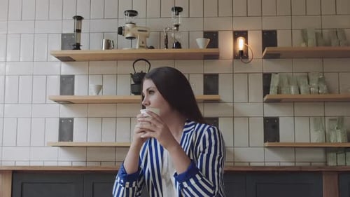 A Young, Beautiful Woman Drinking Coffee In Cafe.