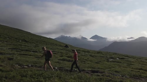 Two Girls Walking On The Trail Path On Mountain In Norway - tracking shot