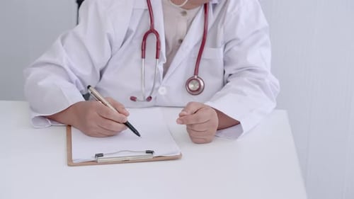 Close-up hand Asian doctor, elderly woman, hold pen in hand as prepare write on paper, While in exam