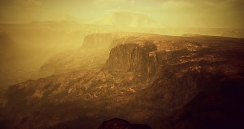 Rocky Landscape Under Hazy Light Showcasing Erosion and Geological Features