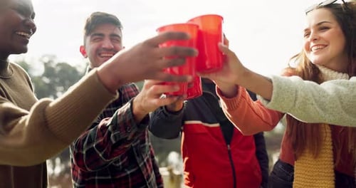 Friends Toasting Together with Red Cups Outdoors