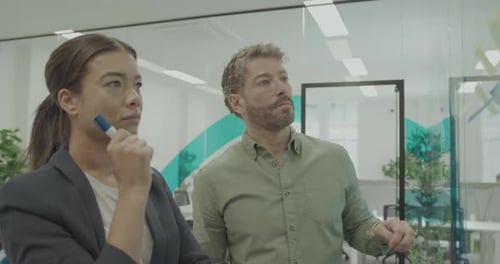 Business People in Casual Office Meeting, Sticking Notes on Glass wall
