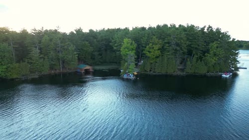 Aerial Pullback of Forested Shoreline and Calm Lake in Quebec