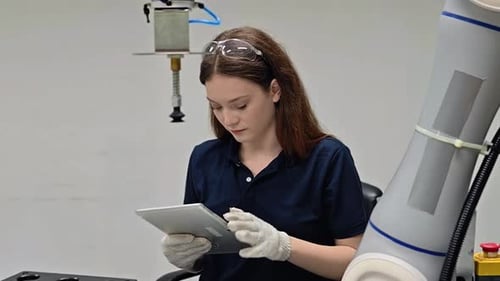 Robotic automation in industrial assembly lines demonstrated by skilled technician