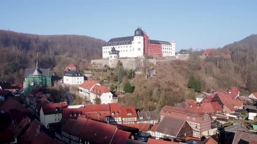 Stolberg city, castle and church Martin on a sunny day, Harz, Germany - rotating aerial view