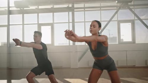 Slow Motion Video of Athletic Team Doing Side Lunges and Bending Body Forward During Fitness Workout
