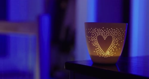 Candle Light Glowing in Dark Room