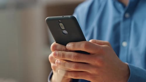 Close up of Man Holding and Using Phone