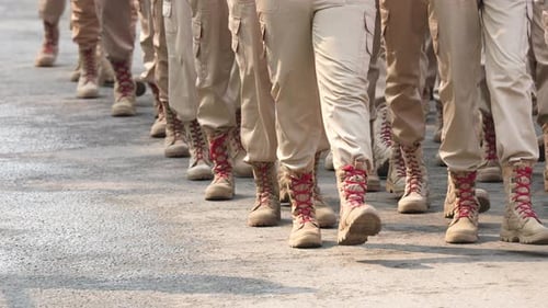 Troops Marching in Step Wearing Uniforms and Boots