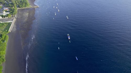 Aerial View of Boats and Pier at Black Sand Beach in Aimere, Indonesia