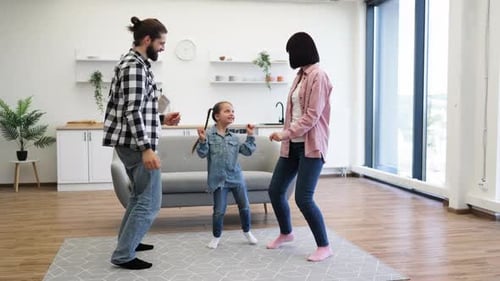 Family Dancing Together in Living Room