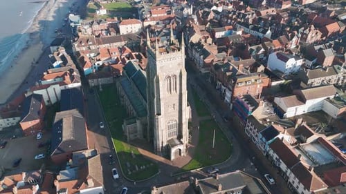 Aerial view of historic Cromer church, town, and coastline with a scenic seaside atmosphere