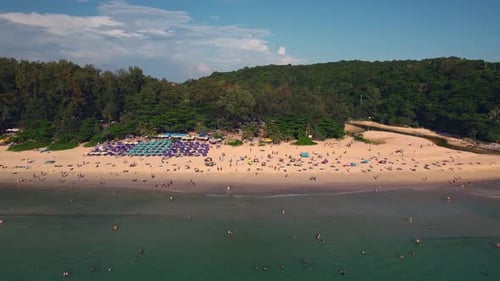 Beach with People Water Clouds Sky and a Natural Landscape
