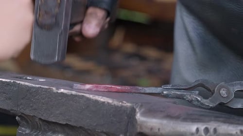 Blacksmith Forging Red Hot Metal on Anvil