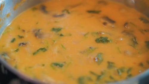 Bright Orange Soup with Meat and Vegetables is Bubbling