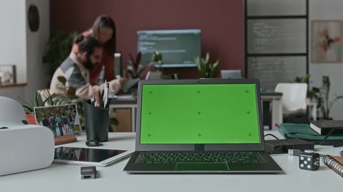 Timelapse of Laptop with Chromakey Screen on Desk at IT Startup