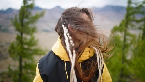 Young Woman Enjoying Wind in the Mountains
