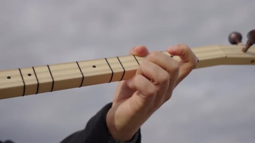 Playing traditional Turkish string instrument Saz