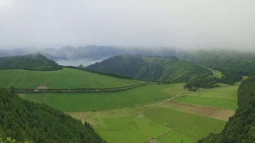 A Lush Green Field with a Mountain in the Background