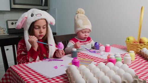 Children Paint Eggs and Prepare for Easter Holidays