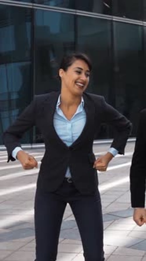 Business Team Celebrates Success Outside Office Building