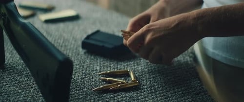 Close Up Hands Loading Bullets into a Magazine