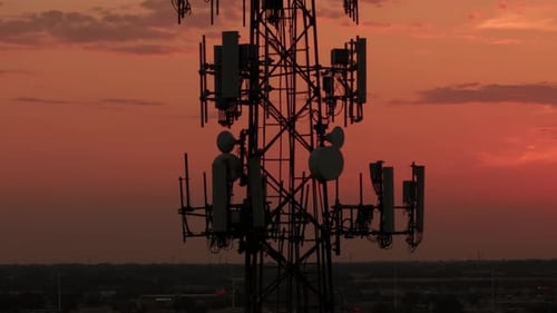 Television or Radio Telephone Tower in a Cityscape at Sunset Time Aerial Zoom Shot