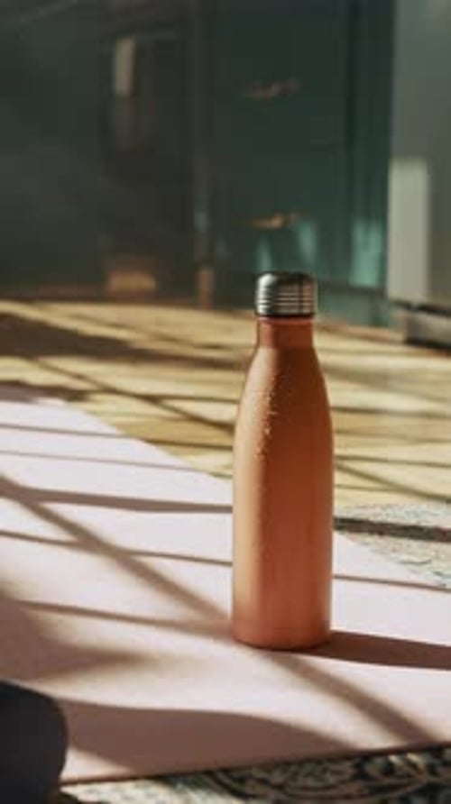 Water Bottle on Yoga Mat in Sunlight