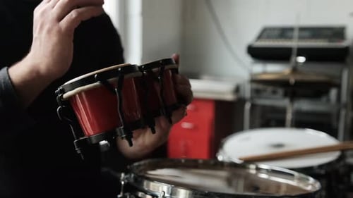 Playing Red Bongos at a Drum Set