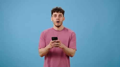 Man Celebrates Good News on Smartphone