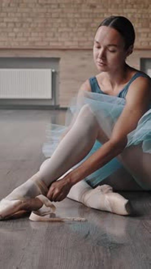 Ballerina Puts on Pointe Shoes to Dance Ballet in Studio