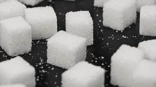 Sugar Cubes Rotate on the Table CloseUp
