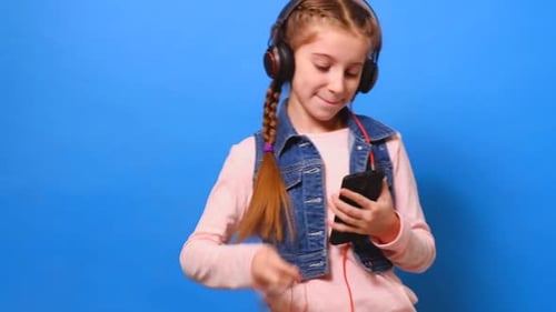 Girl with Headphones Using Smartphone