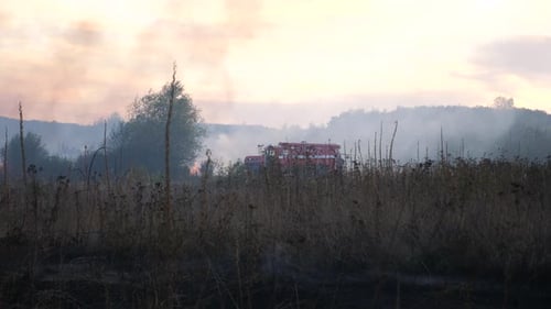 Fire Engine Parked at the Place of Emergency Big Red Truck with Blue Flashing Warning Light Stands