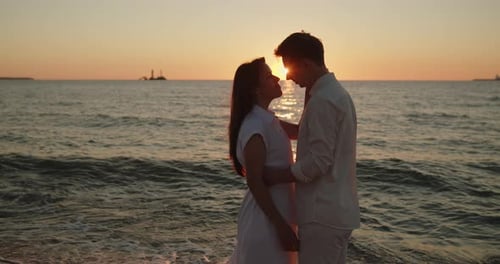 Couple Kissing in Sunset Light Standing Together on the Beach Closeup