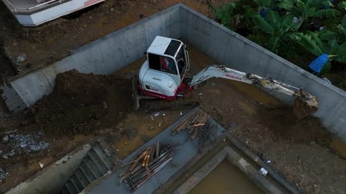 Excavator Digging Foundation Aerial View
