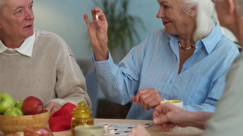 Seniors Gather Around Table Playing Bingo Game