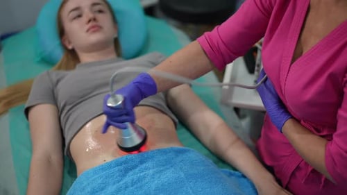 Woman Receiving Non-Invasive Medical Treatment on Stomach