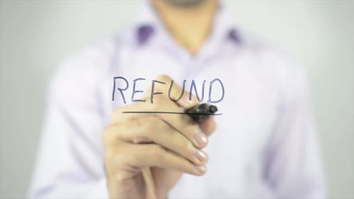 Man Writes the Word Refund on Clear Surface