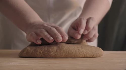 Woman Hands Close Up Kneading Dough on Floured Table Preparing Home Made Sourdough Bread