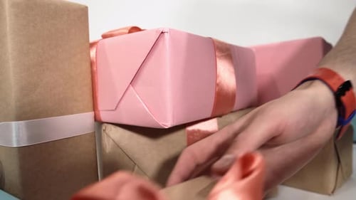 Closeup View of Caucasian Hands Taking Giftboxes From the Pile Lying on the Floor