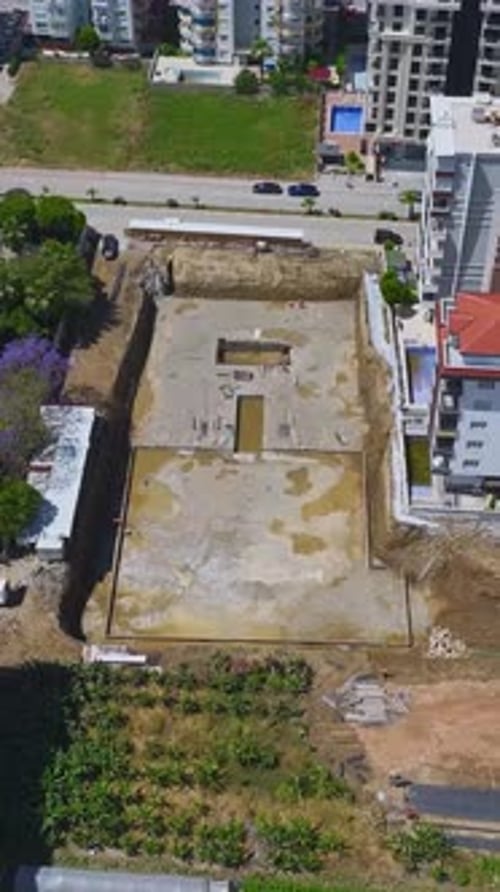 Vertical Video Workers Pour Concrete Into the Foundation for a Residential Building Laying the Base